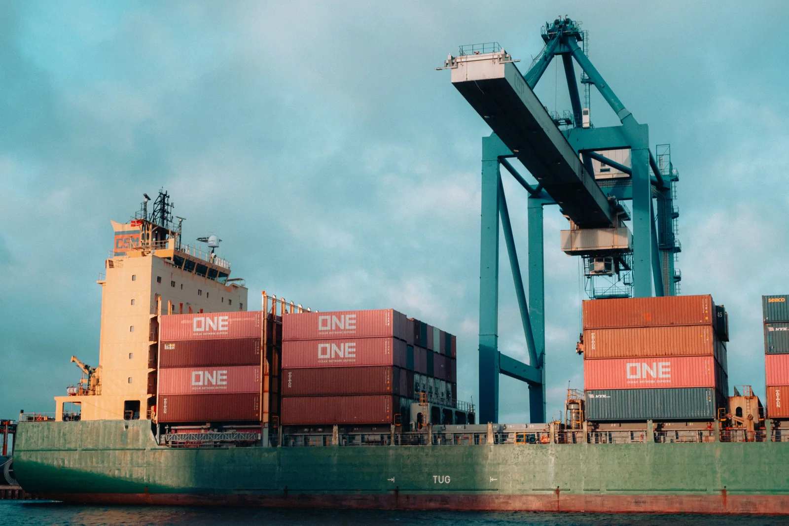 Container ship and cranes at a working cargo port